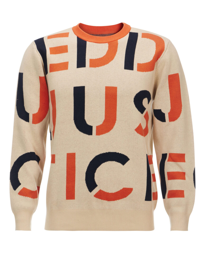 A beige sweater with an orange and black pattern on it.