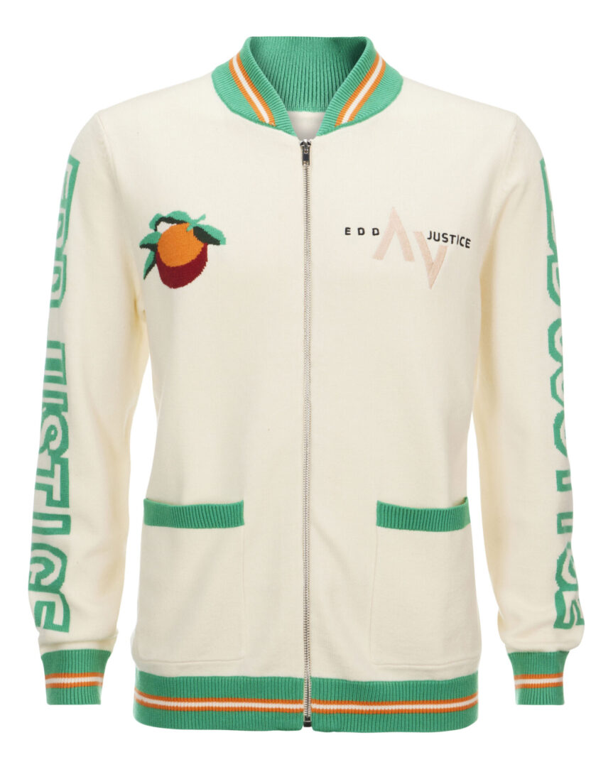 A white jacket with green trim and an orange on the front.